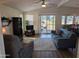 Bright living room with patio access, comfy seating, and hardwood floors at 17200 W Bell Rd # 1599, Surprise, AZ 85374