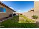 Spacious backyard with grassy lawn, and a grilling area at 17502 W Blue Sky Dr, Surprise, AZ 85387