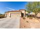 Single-story house with three-car garage and desert landscaping at 17502 W Blue Sky Dr, Surprise, AZ 85387