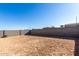 Empty lot with block wall and sandy ground at 17645 W Jackson St, Goodyear, AZ 85338