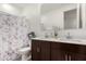 Bathroom with double sinks and a floral shower curtain at 17645 W Jackson St, Goodyear, AZ 85338