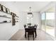 Bright dining room featuring a table for six and access to the backyard at 17645 W Jackson St, Goodyear, AZ 85338