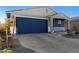 New single-story home with blue garage door and landscaped yard at 17645 W Jackson St, Goodyear, AZ 85338