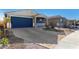 New single-story home with blue garage door and landscaped yard at 17645 W Jackson St, Goodyear, AZ 85338