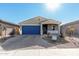 New single-story home with blue garage door and landscaped yard at 17645 W Jackson St, Goodyear, AZ 85338