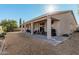 Covered patio, grassy area, and mature trees at 18354 W Hatcher Rd, Waddell, AZ 85355