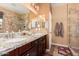 Double-sink bathroom with granite countertops and a walk-in shower at 18354 W Hatcher Rd, Waddell, AZ 85355