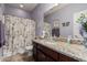 Clean bathroom with granite countertop and floral accents at 18354 W Hatcher Rd, Waddell, AZ 85355