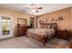 Main bedroom with a king-size bed and private access to the backyard at 18354 W Hatcher Rd, Waddell, AZ 85355