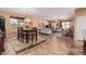 Open dining area with a wooden table and view into the living room at 18354 W Hatcher Rd, Waddell, AZ 85355