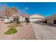 Single-story home with a two-car garage and well-maintained landscaping at 18354 W Hatcher Rd, Waddell, AZ 85355