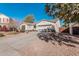 House exterior showcasing a two-car garage and desert landscaping at 18354 W Hatcher Rd, Waddell, AZ 85355