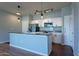 Modern kitchen with island, stainless steel appliances and white cabinets at 18416 N Cave Creek Rd # 3044, Phoenix, AZ 85032