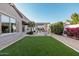 Landscaped backyard with artificial turf and pergola at 19024 W Solano Dr, Litchfield Park, AZ 85340