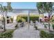 Relaxing backyard patio with pergola, seating, and lush landscaping at 19024 W Solano Dr, Litchfield Park, AZ 85340