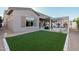 Artificial turf backyard with pergola and house view at 19024 W Solano Dr, Litchfield Park, AZ 85340