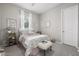 Charming bedroom with a floral bedspread and window with white curtains at 19024 W Solano Dr, Litchfield Park, AZ 85340