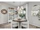 Bright dining room with round wooden table and white chairs at 19024 W Solano Dr, Litchfield Park, AZ 85340