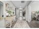 Elegant entryway with a console table, mirror, and patterned rug at 19024 W Solano Dr, Litchfield Park, AZ 85340