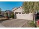 Front view of a two-story house with a beige facade and a two-car garage at 19024 W Solano Dr, Litchfield Park, AZ 85340