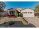 Two-story house with beige facade, two-car garage, and landscaping at 19024 W Solano Dr, Litchfield Park, AZ 85340