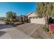 Two-story house with a beige facade and a two-car garage at 19024 W Solano Dr, Litchfield Park, AZ 85340