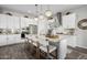 Spacious kitchen with white cabinets, breakfast bar, and stainless steel appliances at 19024 W Solano Dr, Litchfield Park, AZ 85340