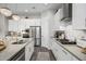 Modern kitchen with white cabinets, stainless steel appliances, and a large island at 19024 W Solano Dr, Litchfield Park, AZ 85340