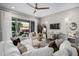 Living room with white sofas, a statement wall, and sliding glass doors at 19024 W Solano Dr, Litchfield Park, AZ 85340