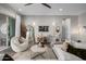 Living room with white sofas, a statement wall, and access to patio at 19024 W Solano Dr, Litchfield Park, AZ 85340