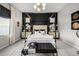 Luxurious main bedroom with a black canopy bed and gold accents at 19024 W Solano Dr, Litchfield Park, AZ 85340