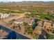 Aerial view showcasing a house and neighboring homes in a golf community at 19115 E Tonto Verde Dr, Rio Verde, AZ 85263