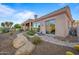 Landscaped backyard with stone pathway, desert plants, and a partial view of the house at 19115 E Tonto Verde Dr, Rio Verde, AZ 85263