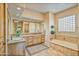 Elegant bathroom with double vanity and a large soaking tub at 19115 E Tonto Verde Dr, Rio Verde, AZ 85263