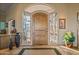 Elegant entryway with wood door and stained glass at 19115 E Tonto Verde Dr, Rio Verde, AZ 85263