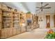 Living room with extensive built-in wooden shelving and media center at 19115 E Tonto Verde Dr, Rio Verde, AZ 85263