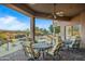 Covered patio with seating area overlooking the pool and scenic view at 19115 E Tonto Verde Dr, Rio Verde, AZ 85263