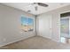 Bright bedroom with ceiling fan, carpet, and sliding door at 19359 E Canary Way, Queen Creek, AZ 85142