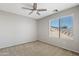 Spacious bedroom with ceiling fan and carpeted floor at 19359 E Canary Way, Queen Creek, AZ 85142