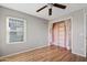 Bedroom with wood floors, ceiling fan and built-in shelving at 19359 E Canary Way, Queen Creek, AZ 85142