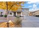 Two-story house with a gray facade,fall leaves and a neatly landscaped front yard at 19359 E Canary Way, Queen Creek, AZ 85142