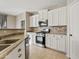 Modern kitchen with white cabinets, stone backsplash and stainless steel appliances at 19359 E Canary Way, Queen Creek, AZ 85142