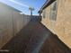 Gravel backyard with block wall and a palm tree at 19422 N Smith Dr, Maricopa, AZ 85139