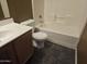 Clean bathroom with tub, shower, and wood vanity at 19422 N Smith Dr, Maricopa, AZ 85139