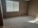 Simple bedroom with carpeted floors and window at 19422 N Smith Dr, Maricopa, AZ 85139