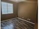 Bedroom with wood flooring and window coverings at 19422 N Smith Dr, Maricopa, AZ 85139