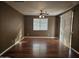 Bright living room featuring wood flooring and ceiling fan at 19422 N Smith Dr, Maricopa, AZ 85139