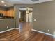 View from kitchen into living room with wood-look floors at 19422 N Smith Dr, Maricopa, AZ 85139