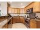 Modern kitchen with granite countertops and wood cabinets at 19475 N Grayhawk Dr # 2169, Scottsdale, AZ 85255