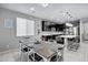 Open kitchen features dark cabinetry, breakfast bar, and dining area at 19538 N Crestview Ln, Maricopa, AZ 85138